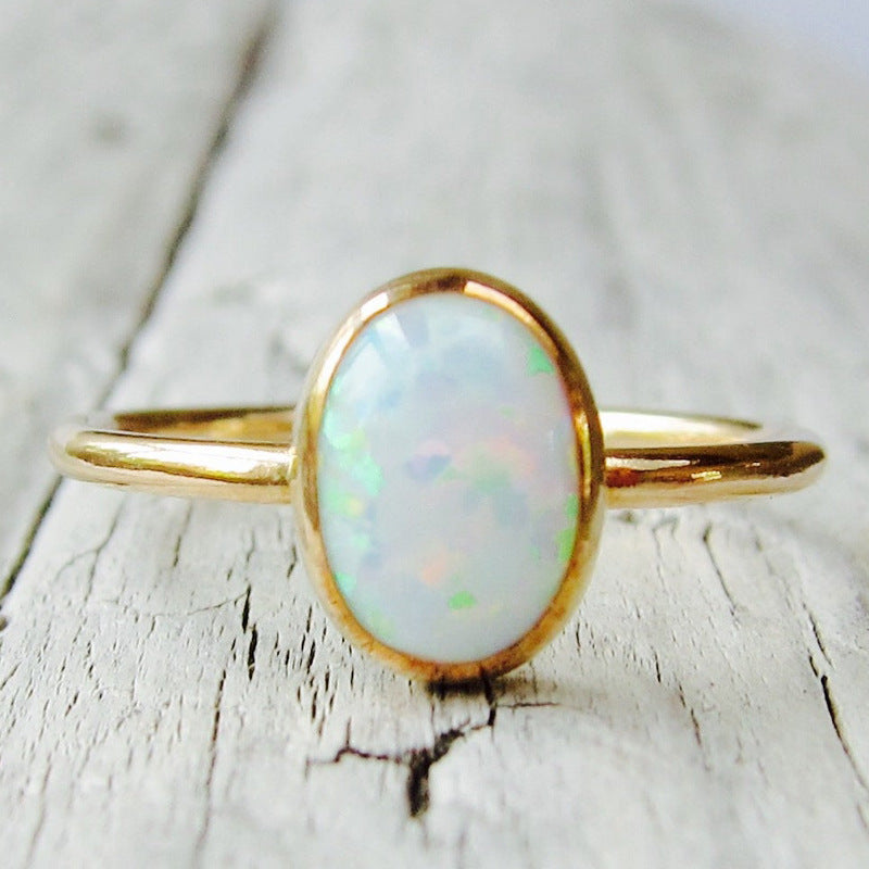 Gold-tone ring with white opal-look oval stone – photo 2