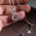 Sparkling round halo pendant necklace on a silver-tone chain