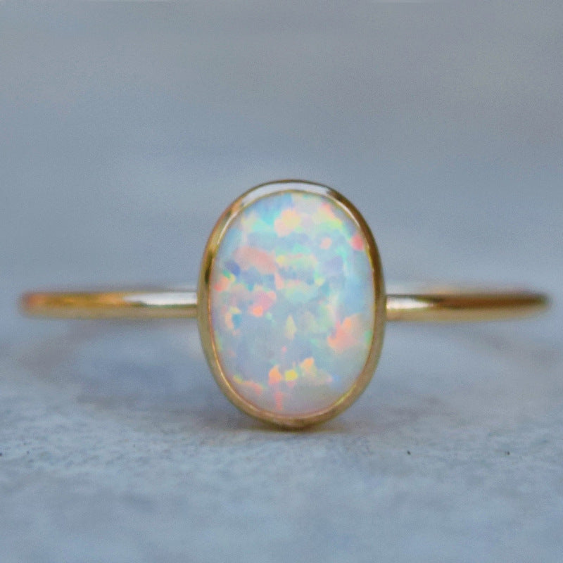 Gold-tone ring with white opal-look oval stone – photo 6