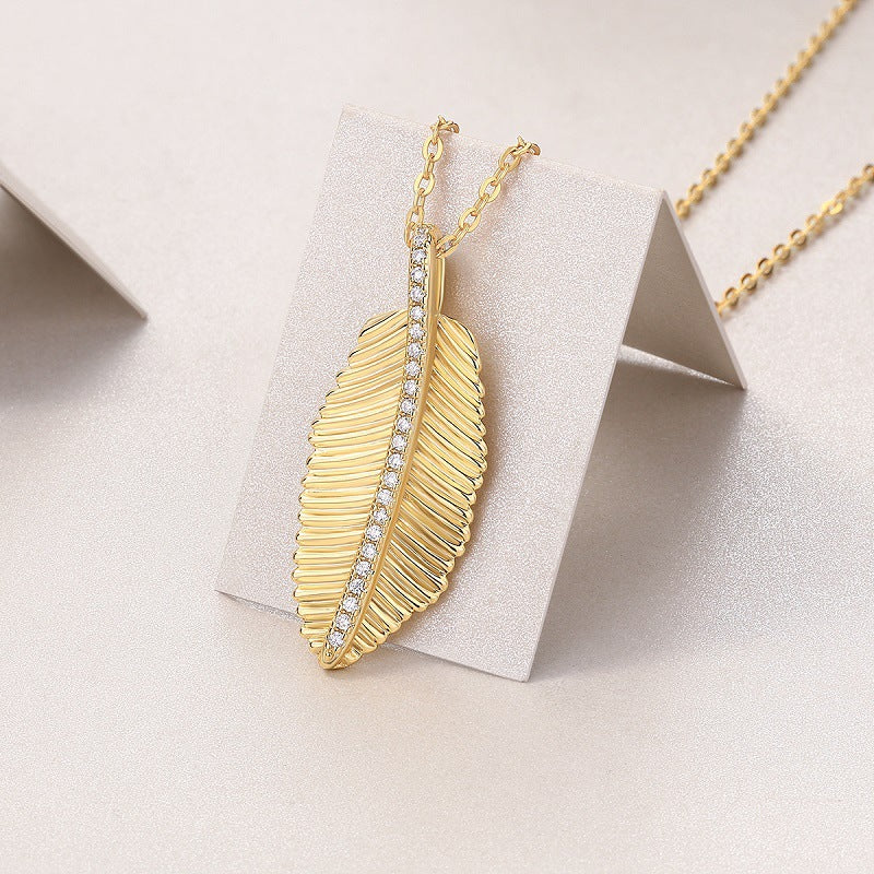 Gold-tone leaf pendant necklace with sparkling stones – photo 5
