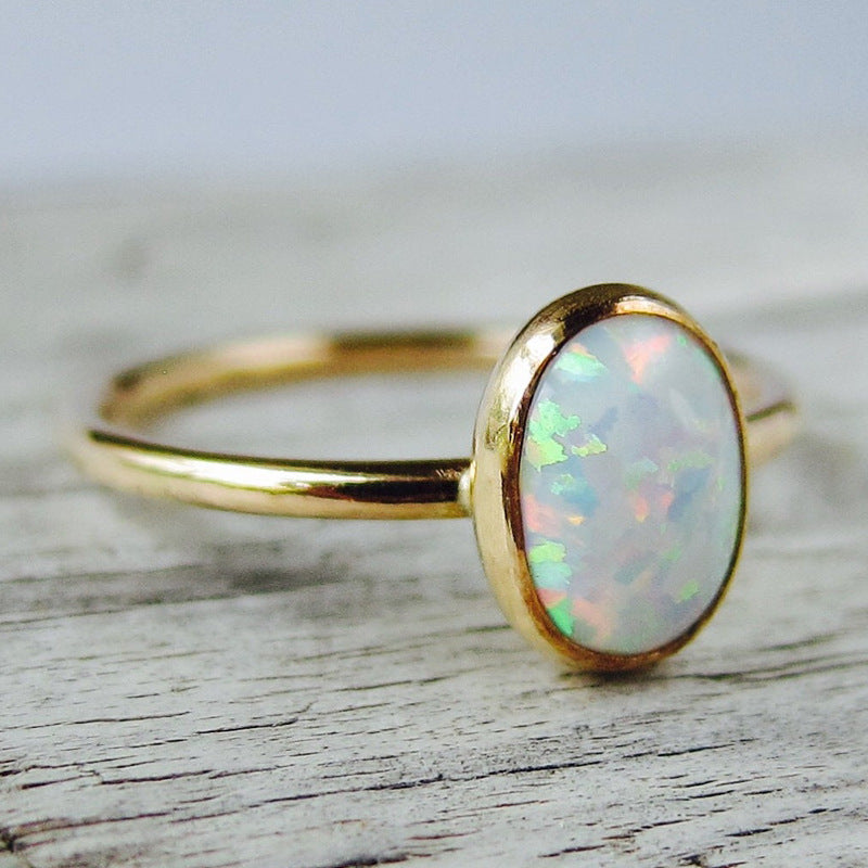 Gold-tone ring with white opal-look oval stone – photo 3