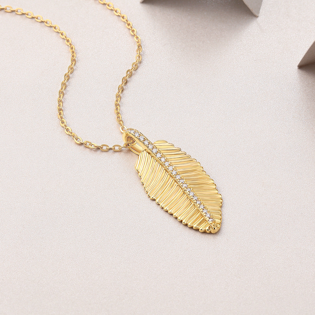 Gold-tone leaf pendant necklace with sparkling stones
