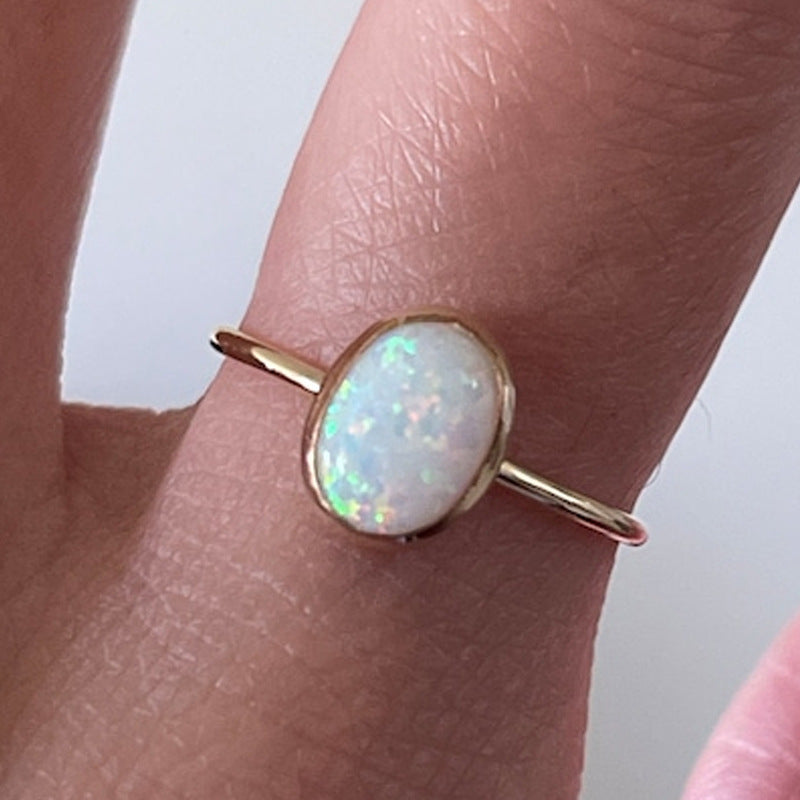 Gold-tone ring with white opal-look oval stone – photo 4